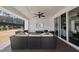 Covered patio with outdoor seating, fan, and TV; ideal for entertaining or relaxing outdoors at 113 Amberwing Ct, Holly Springs, NC 27540