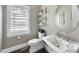 Contemporary powder room features a floating vanity, sleek fixtures, and stylish decor at 113 Amberwing Ct, Holly Springs, NC 27540