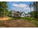 Back exterior view of the home, highlighting a covered porch and spacious yard at 1218 Red Cedar Ct, Youngsville, NC 27596