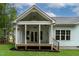 Inviting covered back porch with a ceiling fan, access to the backyard, and stylish railings at 1218 Red Cedar Ct, Youngsville, NC 27596