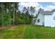 The home boasts a spacious backyard with lush lawn and perimeter of trees at 1218 Red Cedar Ct, Youngsville, NC 27596