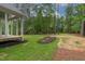 A neatly landscaped backyard featuring a well-maintained lawn, mulch beds, and pine straw at 1218 Red Cedar Ct, Youngsville, NC 27596