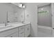 Bright bathroom featuring double vanity, modern fixtures, and a tiled shower/bath enclosure at 1218 Red Cedar Ct, Youngsville, NC 27596