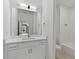 A modern bathroom with a sleek vanity, ample storage, and a shower/tub combo offering convenience and style at 1218 Red Cedar Ct, Youngsville, NC 27596