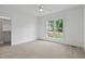 Bright bedroom features neutral carpet, white walls, ceiling fan, and a walk-in closet at 1218 Red Cedar Ct, Youngsville, NC 27596