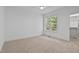 Bedroom features neutral carpet, a window with view, and closet at 1218 Red Cedar Ct, Youngsville, NC 27596