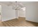 Large dining room with a unique modern chandelier and white walls at 1218 Red Cedar Ct, Youngsville, NC 27596