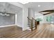 Open concept home with hardwood floors, grey accent wall and a staircase with wooden banister at 1218 Red Cedar Ct, Youngsville, NC 27596