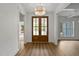Inviting foyer featuring wood-look floors, double doors, and elegant chandelier at 1218 Red Cedar Ct, Youngsville, NC 27596