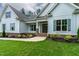 Charming, light-blue home boasts a beautifully landscaped front yard and covered entryway at 1218 Red Cedar Ct, Youngsville, NC 27596