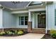 Inviting front exterior with brick accents, a covered entrance, and well-manicured landscaping at 1218 Red Cedar Ct, Youngsville, NC 27596