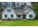 A well-manicured lawn complements this charming home with blue siding, shutters, and brick accents on the facade at 1218 Red Cedar Ct, Youngsville, NC 27596