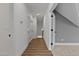 Hallway with wood-look flooring, white walls, and views into adjacent rooms at 1218 Red Cedar Ct, Youngsville, NC 27596