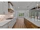 Bright kitchen with white cabinets, herringbone backsplash, quartz countertops and stainless steel appliances at 1218 Red Cedar Ct, Youngsville, NC 27596