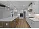 Modern kitchen with stainless steel appliances, custom cabinets, and a spacious island at 1218 Red Cedar Ct, Youngsville, NC 27596