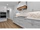 Modern kitchen with stainless appliances, white cabinetry, and stylish vent hood at 1218 Red Cedar Ct, Youngsville, NC 27596