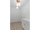 Clean laundry room with cabinet storage, unique floor tiles, and modern lighting at 1218 Red Cedar Ct, Youngsville, NC 27596