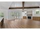 Spacious living room featuring wood beams, a fireplace, and access to the outdoors at 1218 Red Cedar Ct, Youngsville, NC 27596