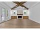Spacious living room with hardwood floors, wooden beams, and a fireplace at 1218 Red Cedar Ct, Youngsville, NC 27596