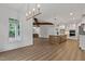 Spacious open concept living space with hardwood floors, exposed beams, and a modern kitchen at 1218 Red Cedar Ct, Youngsville, NC 27596