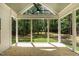 Inviting screened porch with wood flooring and serene views of the surrounding yard at 1218 Red Cedar Ct, Youngsville, NC 27596