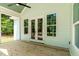 Charming porch featuring wood flooring, French doors, and views of the surrounding greenery at 1218 Red Cedar Ct, Youngsville, NC 27596