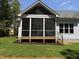Charming screened porch with wood flooring, white trim, and a ceiling fan providing a relaxing outdoor space at 1218 Red Cedar Ct, Youngsville, NC 27596