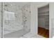 Luxurious shower featuring glass enclosure, marble-patterned tile, and seat at 1218 Red Cedar Ct, Youngsville, NC 27596