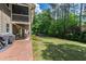 Expansive backyard featuring a well-maintained lawn, lush greenery, and a covered patio area perfect for outdoor relaxation at 1305 Kimberly Dr, Raleigh, NC 27609