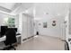 Versatile basement space perfect for recreation or storage, featuring white walls and natural light at 1305 Kimberly Dr, Raleigh, NC 27609