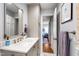 Bathroom featuring double doors, a mirror, granite counters and vanity with gold fixtures at 1305 Kimberly Dr, Raleigh, NC 27609