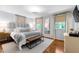 Well-lit bedroom featuring wood floors, a stylish chandelier, and an accent bench at 1305 Kimberly Dr, Raleigh, NC 27609