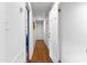 Hallway with wood floors, white walls, and multiple doors leading to other rooms at 1305 Kimberly Dr, Raleigh, NC 27609