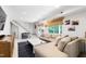 Bright, spacious living room with neutral walls, comfortable sectional, and natural light from large windows at 1305 Kimberly Dr, Raleigh, NC 27609