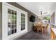 Covered porch featuring a dining table and chairs, a ceiling fan, and a peaceful outdoor view at 1305 Kimberly Dr, Raleigh, NC 27609