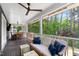 Inviting covered porch featuring wood ceiling, ceiling fans, and comfortable seating with views of the lush backyard at 1305 Kimberly Dr, Raleigh, NC 27609