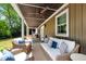 Covered porch with comfortable seating and a ceiling fan at 1305 Kimberly Dr, Raleigh, NC 27609