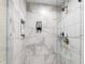Modern shower with marble tiling, a rain shower head, and built-in shelving at 1305 Kimberly Dr, Raleigh, NC 27609