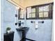 Vintage bathroom with black and blue tile and original fixtures at 1307 Arnette Ave, Durham, NC 27707