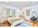 Bright bedroom featuring hardwood floors, neutral decor, and an abundance of natural light at 1307 Arnette Ave, Durham, NC 27707