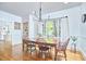 Elegant dining room with hardwood floors, modern chandelier, and large window with natural light at 1307 Arnette Ave, Durham, NC 27707