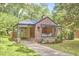 Charming brick home featuring a quaint front porch and well-maintained landscaping, inviting curb appeal at 1307 Arnette Ave, Durham, NC 27707