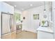 Bright kitchen featuring stainless steel refrigerator, tiled floor, and a window for natural light at 1307 Arnette Ave, Durham, NC 27707