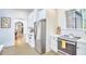 Cozy kitchen with checkerboard floors, stainless steel appliances, and bright white cabinetry at 1307 Arnette Ave, Durham, NC 27707