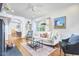 Bright living room featuring hardwood floors, a cozy fireplace, and large windows, creating an inviting atmosphere at 1307 Arnette Ave, Durham, NC 27707