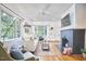 Bright living room featuring hardwood floors, a cozy fireplace, and large windows offering natural light at 1307 Arnette Ave, Durham, NC 27707