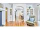 Bright living room with hardwood floors, built-in bookcases, and archway leading to the dining area at 1307 Arnette Ave, Durham, NC 27707