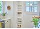 Charming pantry with shelving and a window, perfect for storage in the kitchen area at 1307 Arnette Ave, Durham, NC 27707