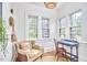 Bright sunroom with exposed brick, terracotta floors, and a cozy reading nook at 1307 Arnette Ave, Durham, NC 27707