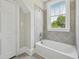Bathroom featuring a window view and tiled shower at 1331 Sunset Ave, Rocky Mount, NC 27804